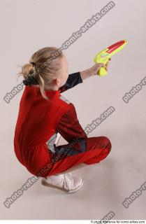 DENISA SITTING POSE WITH GUN